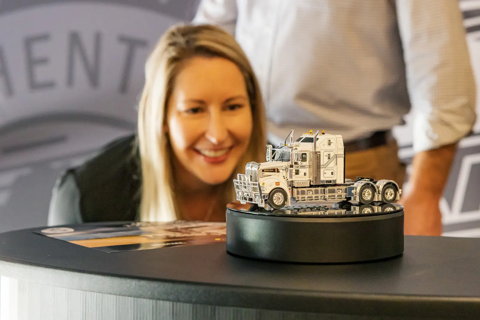 Woman looking at drake collectibles diecast model truck
